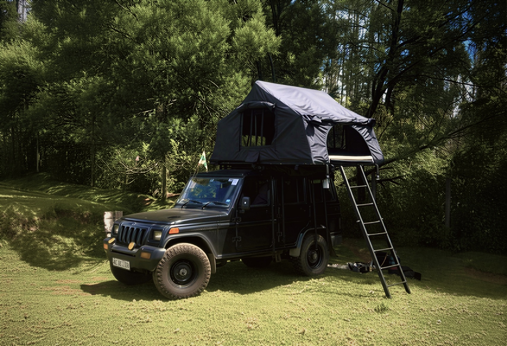 Jeep with rooftop tent in forest